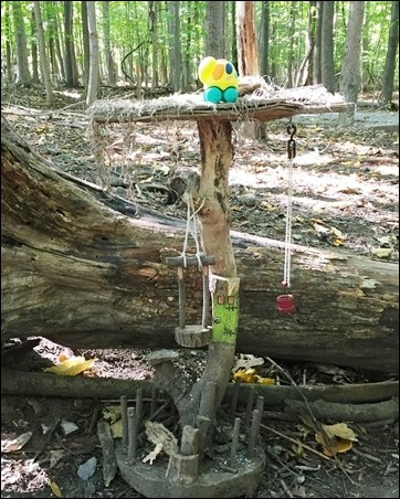 fairy house with water bucket and swing