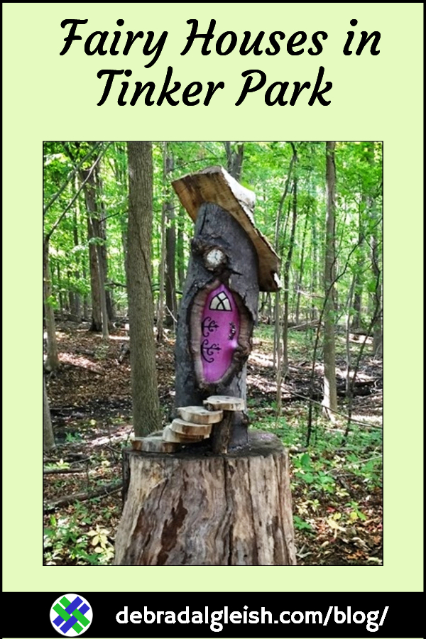 Cute fairy house, with bright purple door, on a tree stump, in Tinker Park, near Rochester NY